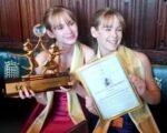 identical twin archers receiving award in Houses of Parliament