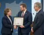 Amy Wood accepts Mid-Ohio ESC three-star BAC award with Tressel